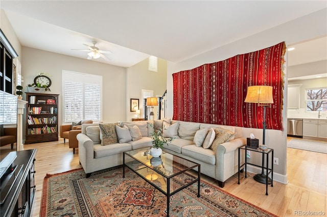 living room with a ceiling fan and wood finished floors