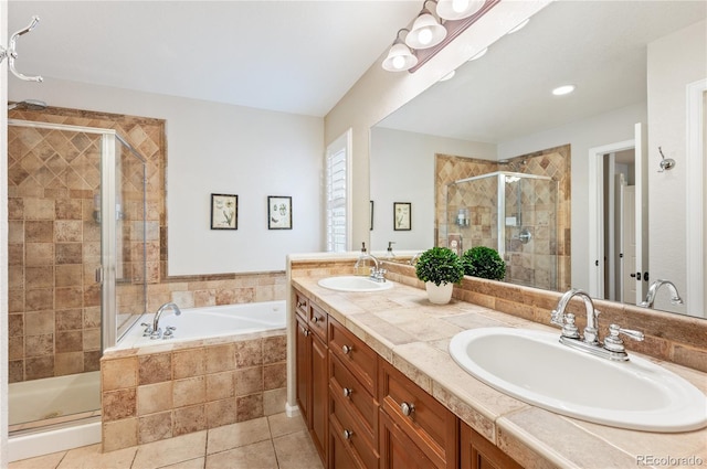 bathroom with a stall shower, tile patterned flooring, a sink, and a bath