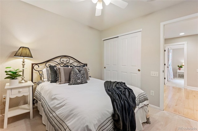 bedroom with a closet, ceiling fan, and baseboards