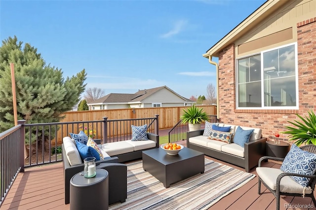 wooden deck with outdoor lounge area and fence