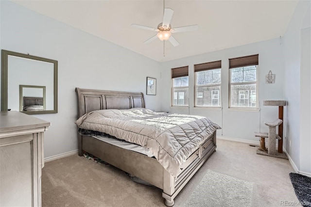 bedroom with ceiling fan, light colored carpet, and lofted ceiling