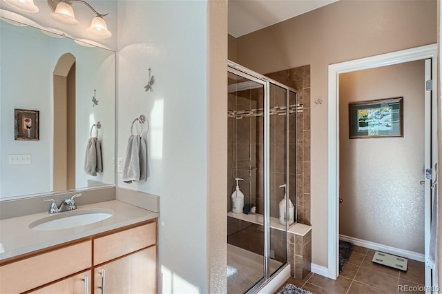 bathroom with vanity, a shower with door, and tile patterned floors