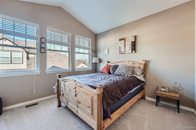 carpeted bedroom with lofted ceiling