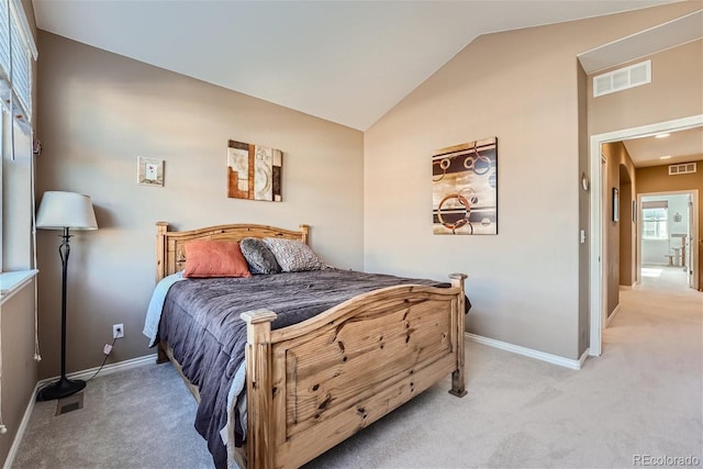 carpeted bedroom featuring lofted ceiling