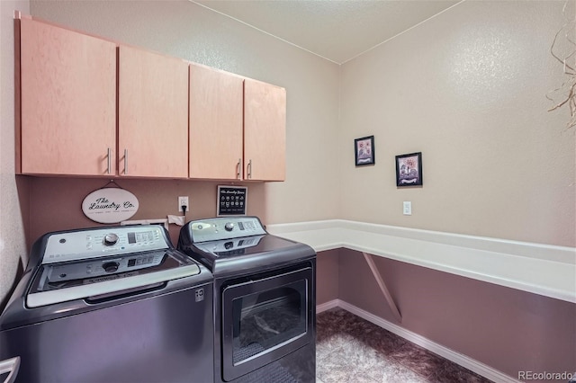 washroom featuring cabinets and separate washer and dryer