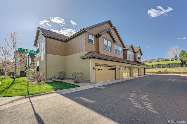 view of side of property with a garage and a yard