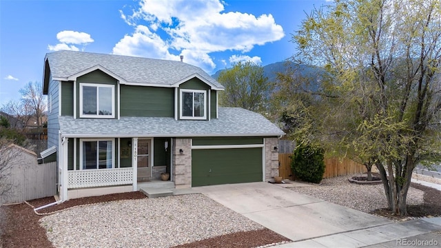 1501 Coolcrest Dr, Colorado Springs, CO 80906 - traditional-style house featuring a porch, a shingled roof, driveway, and an attached garage