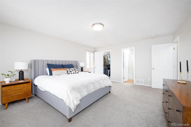1501 Coolcrest Dr, Colorado Springs, CO 80906 - bedroom with carpet flooring, a walk in closet, a closet, a textured ceiling, and baseboards