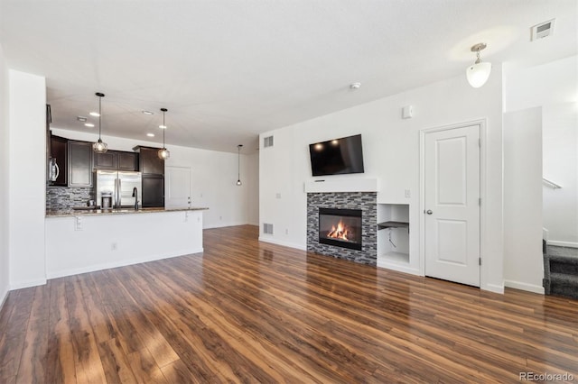 16285 W 62nd Ln Unit C, Arvada, CO 80403 - unfurnished living room with dark wood-style floors, a tile fireplace, stairs, recessed lighting, and baseboards