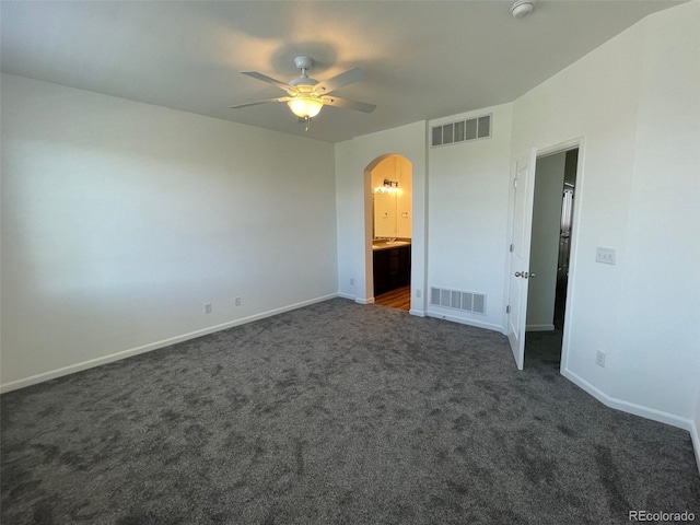 16285 W 62nd Ln Unit C, Arvada, CO 80403 - unfurnished bedroom featuring arched walkways, carpet flooring, ensuite bath, and a ceiling fan