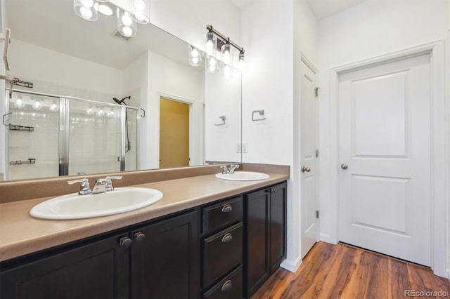 16285 W 62nd Ln Unit C, Arvada, CO 80403 - full bath with a shower stall, double vanity, and wood finished floors