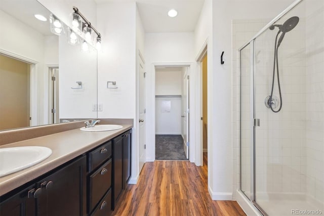 16285 W 62nd Ln Unit C, Arvada, CO 80403 - bathroom with a stall shower, double vanity, and wood finished floors