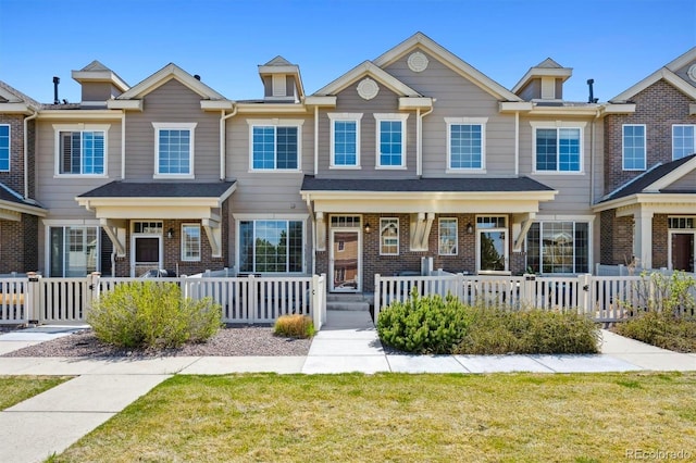 16285 W 62nd Ln Unit C, Arvada, CO 80403 - view of property featuring brick siding and covered porch
