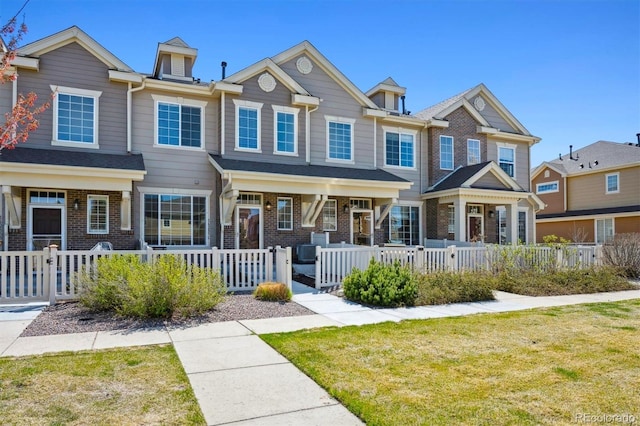 16285 W 62nd Ln Unit C, Arvada, CO 80403 - view of property featuring a fenced front yard and brick siding