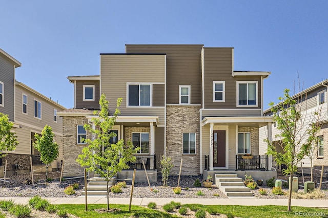 24374 E 42nd Ave, Aurora, CO 80019 - view of front facade featuring a porch and brick siding