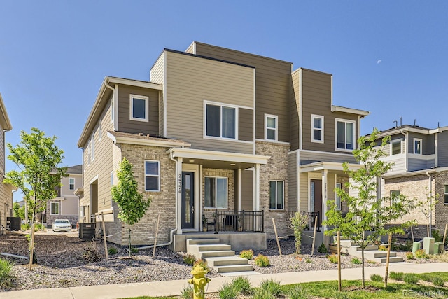 24374 E 42nd Ave, Aurora, CO 80019 - view of front of home with covered porch and central AC unit