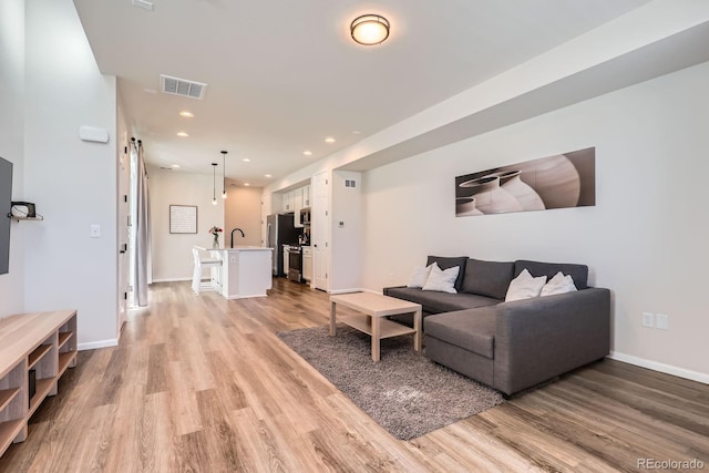 24374 E 42nd Ave, Aurora, CO 80019 - living room with light wood-type flooring, recessed lighting, and baseboards