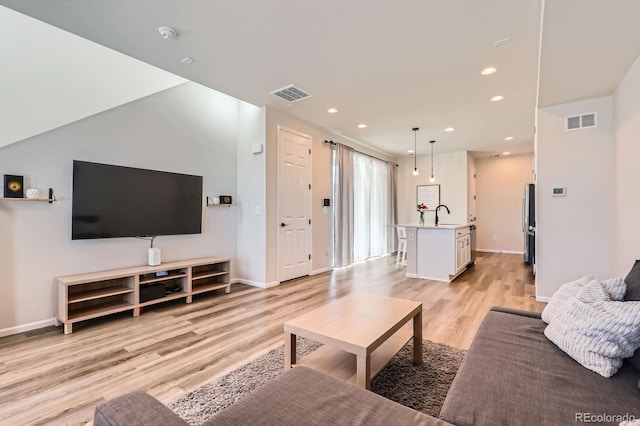 24374 E 42nd Ave, Aurora, CO 80019 - living room with light wood-type flooring, recessed lighting, and baseboards