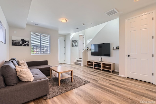 24374 E 42nd Ave, Aurora, CO 80019 - living room featuring light wood-style floors, stairs, and baseboards