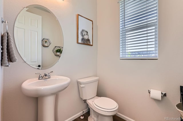 24374 E 42nd Ave, Aurora, CO 80019 - bathroom featuring toilet, baseboards, wood finished floors, and a sink