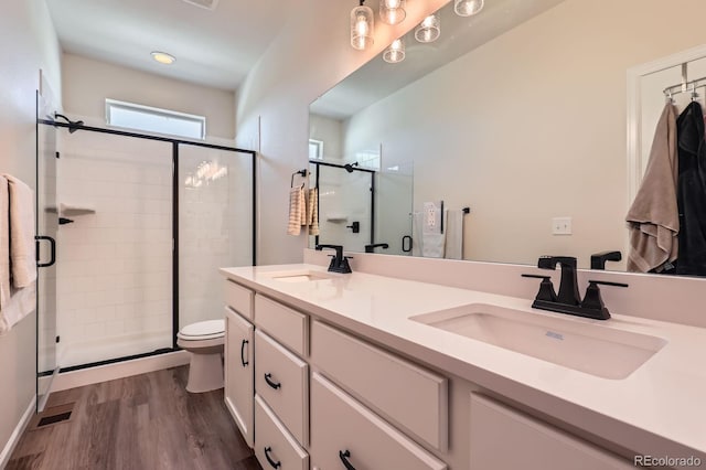 24374 E 42nd Ave, Aurora, CO 80019 - full bath with a stall shower, wood finished floors, toilet, and double vanity