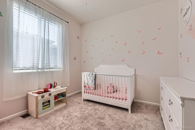 24374 E 42nd Ave, Aurora, CO 80019 - bedroom featuring a crib, light carpet, and baseboards