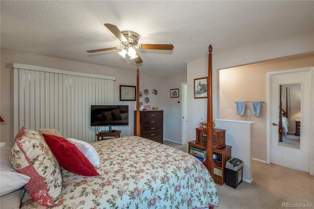 carpeted bedroom with baseboards, ceiling fan, and a textured ceiling