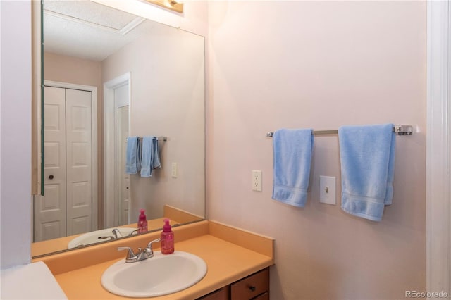 bathroom featuring vanity and a closet