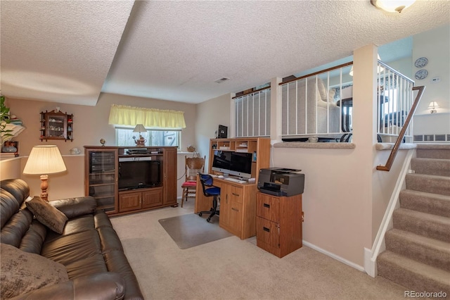 living room with stairs, a textured ceiling, light colored carpet, and visible vents