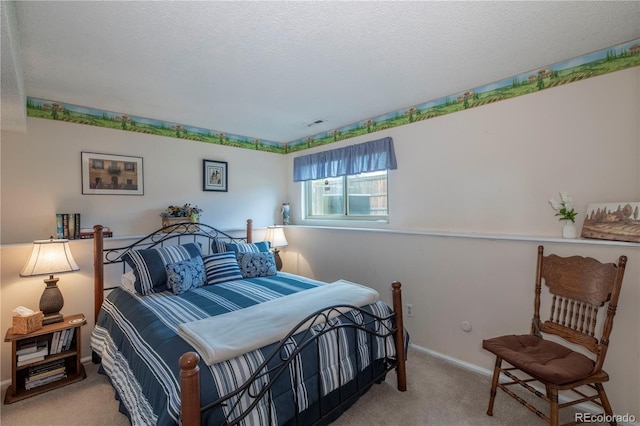 carpeted bedroom with baseboards and a textured ceiling