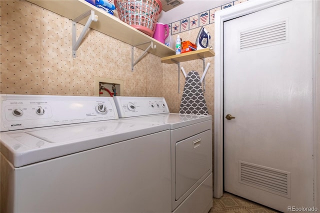 laundry room featuring separate washer and dryer, laundry area, and visible vents