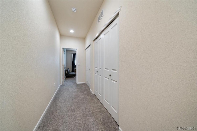hall featuring visible vents, recessed lighting, baseboards, and carpet floors