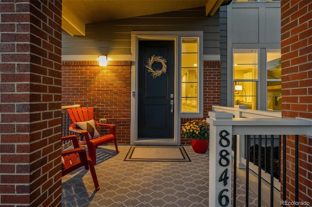 entrance to property featuring brick siding