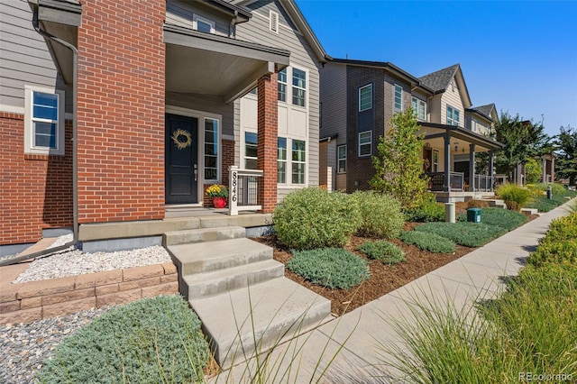 property entrance featuring brick siding