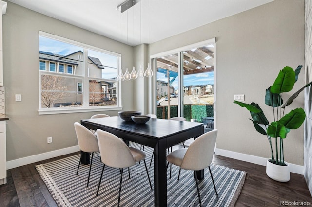 dining space with dark wood-style floors, a wealth of natural light, and baseboards