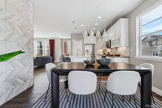 dining room with baseboards, dark wood finished floors, and recessed lighting