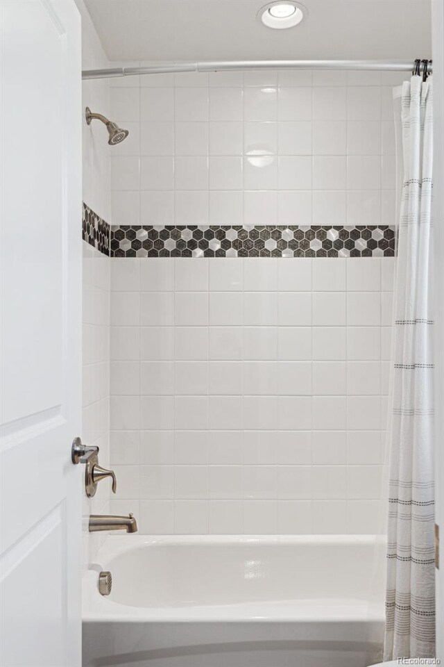 bathroom with shower / bath combination with curtain