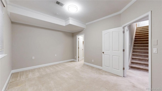 unfurnished bedroom with light colored carpet, crown molding, a spacious closet, and a closet