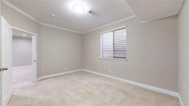 empty room with baseboards, visible vents, ornamental molding, and light colored carpet