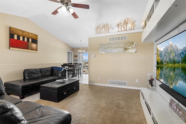 living room with ceiling fan with notable chandelier, light colored carpet, and high vaulted ceiling