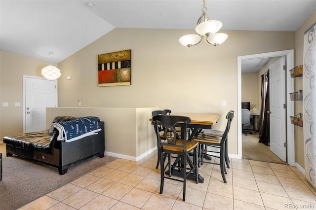 tiled dining room with a notable chandelier and vaulted ceiling