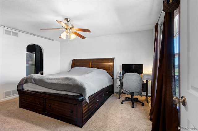 bedroom featuring light colored carpet and ceiling fan