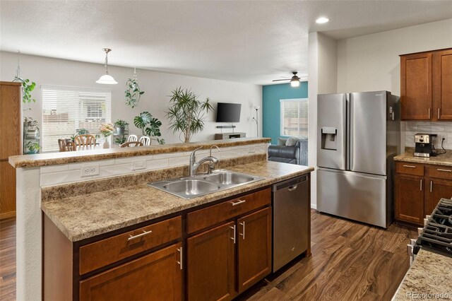 1836 Taos St, Brighton, CO 80603 - kitchen with appliances with stainless steel finishes, a sink, dark wood-style flooring, a ceiling fan, and recessed lighting