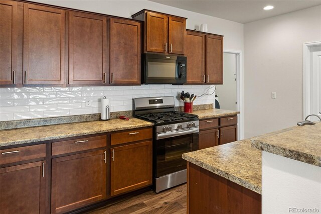 1836 Taos St, Brighton, CO 80603 - kitchen featuring stainless steel range with gas stovetop, black microwave, backsplash, dark wood-style flooring, and recessed lighting