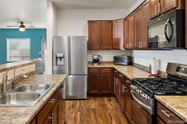 1836 Taos St, Brighton, CO 80603 - kitchen featuring appliances with stainless steel finishes, a sink, a ceiling fan, dark wood-style floors, and light countertops
