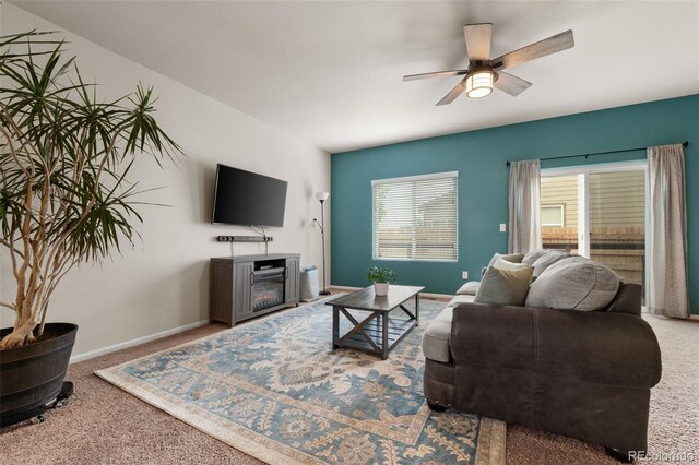 1836 Taos St, Brighton, CO 80603 - living room with carpet floors, a glass covered fireplace, a ceiling fan, and baseboards
