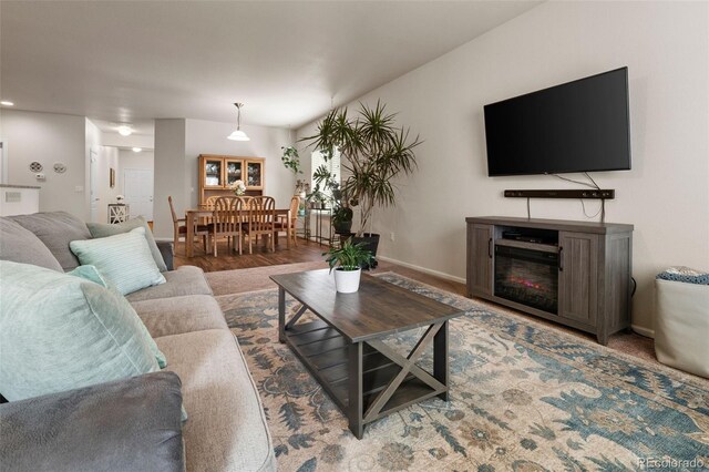 1836 Taos St, Brighton, CO 80603 - living area with baseboards and a glass covered fireplace