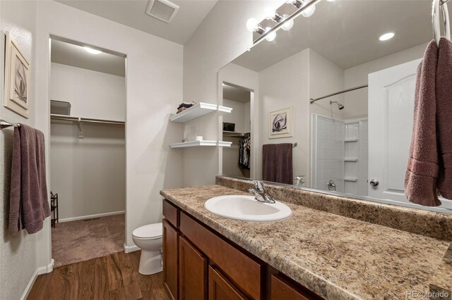 1836 Taos St, Brighton, CO 80603 - full bath featuring toilet, wood finished floors, vanity, and a walk in closet