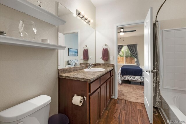 1836 Taos St, Brighton, CO 80603 - full bathroom with wood finished floors, vanity, toilet, connected bathroom, and shower / bath combo