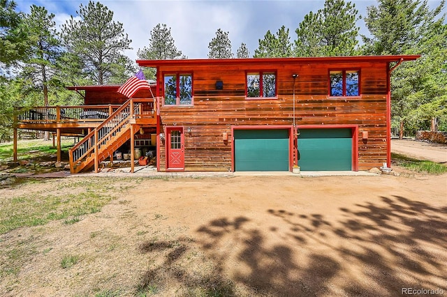 view of front of property with a garage and a deck